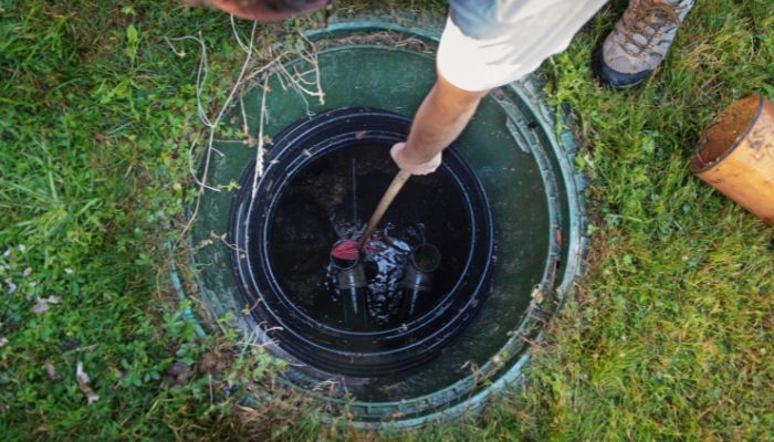 professional plumber removing trash clogging septic tank - Elizabeth Drain and Plumbing Services | Elizabeth, NJ