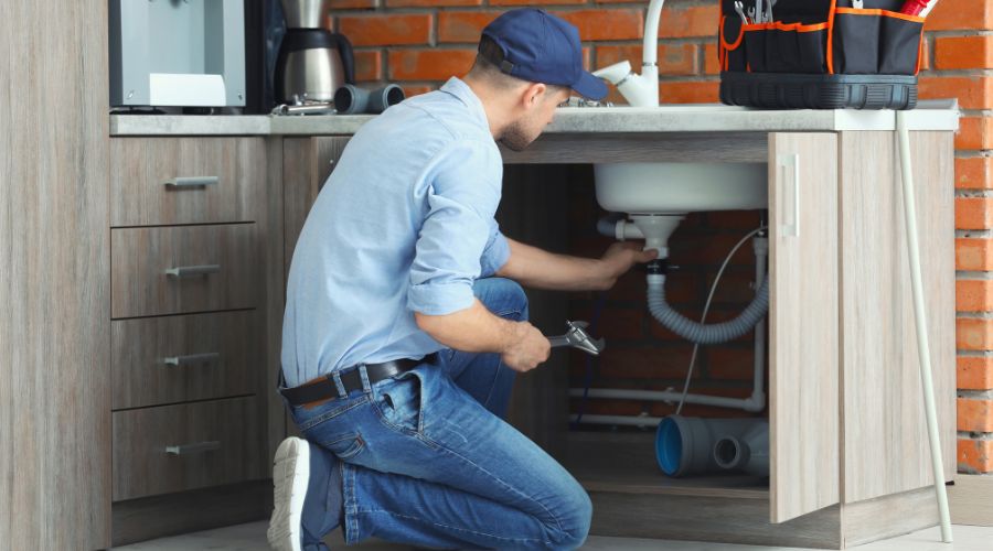 professional plumber fixing sink